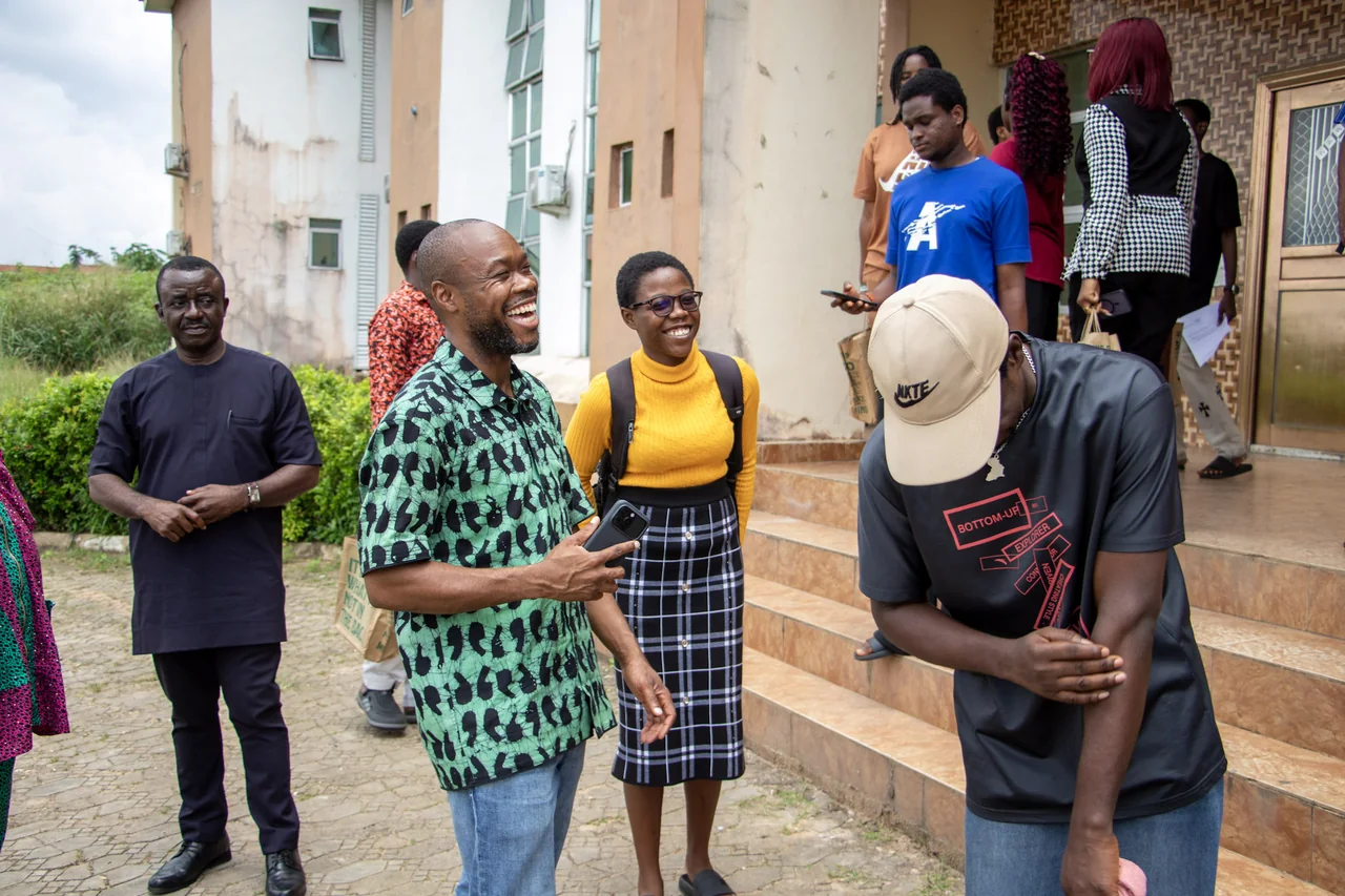 Participants sharing a lighthearted moment outside during the FUTO visit.
